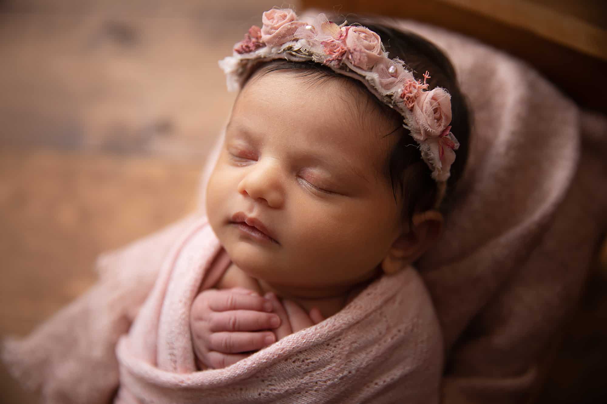 baby girl in pink with floral headband