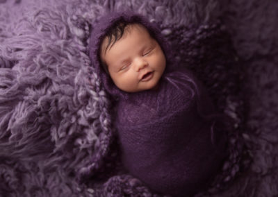 baby girl on purple flokati