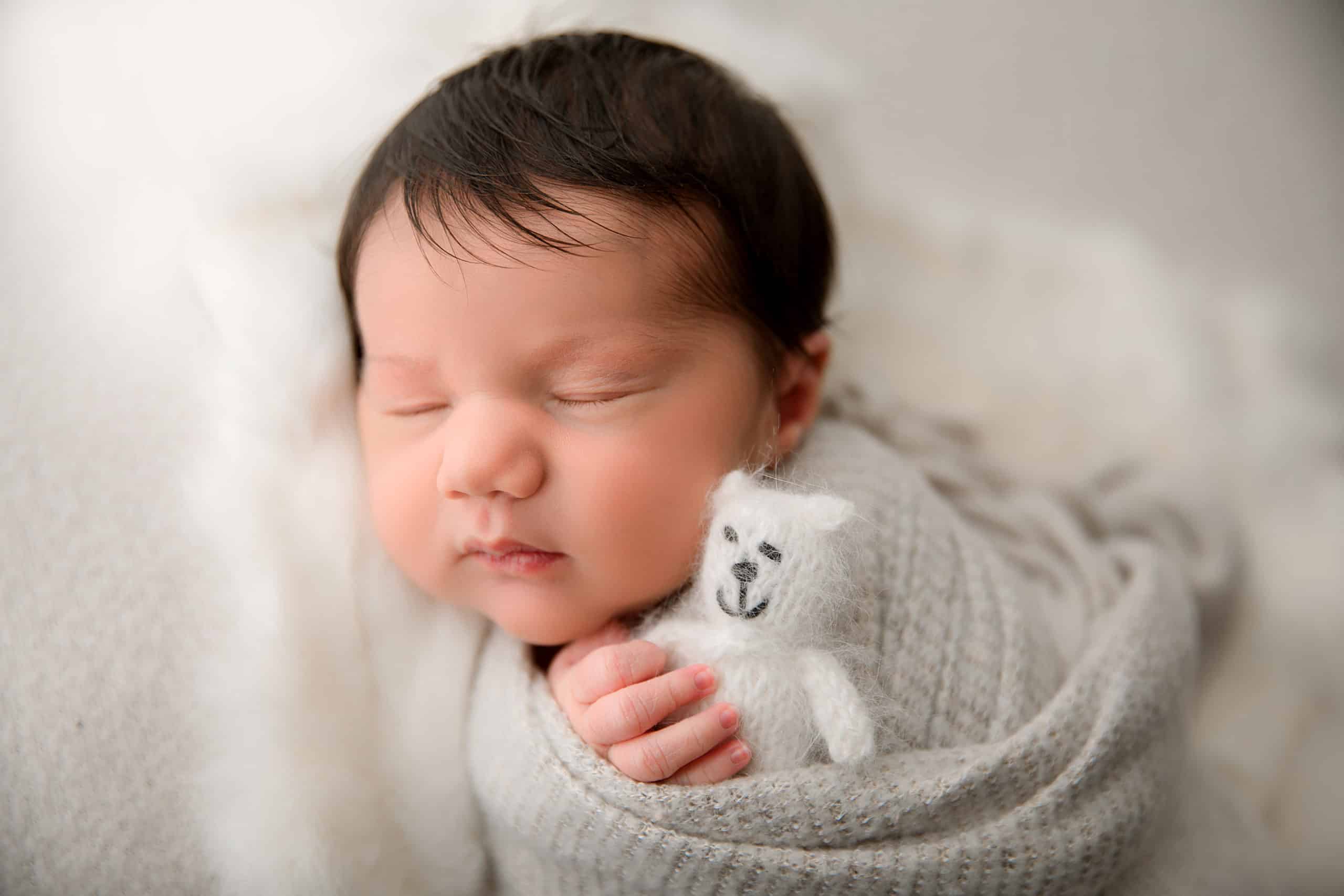 newborn baby with soft toy
