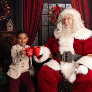 Santa and child having milk and cookies